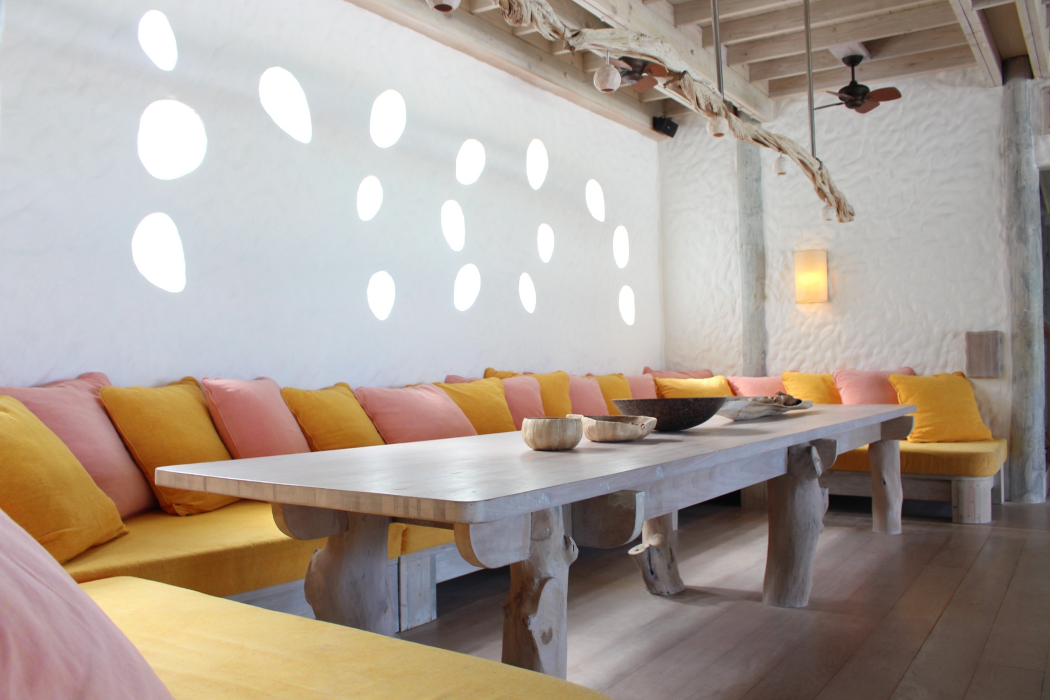 Brightly cushioned dining area inside a Soneva Fushi villa