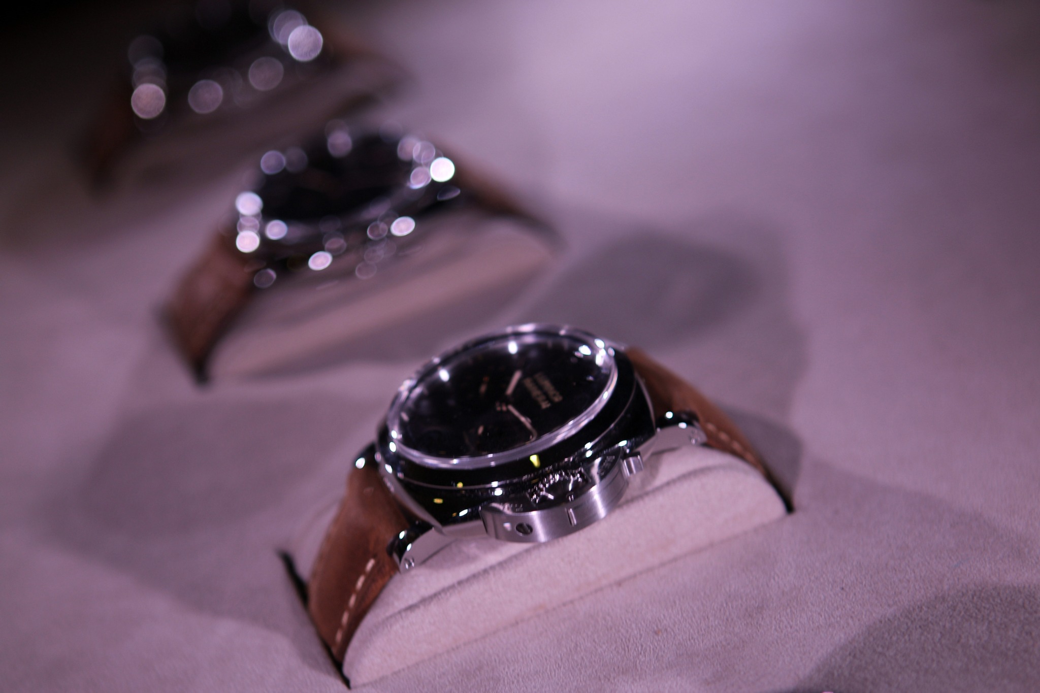 Luxury wristwatches displayed in soft focus